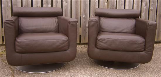 A pair of Natuzzi leather swivel armchairs W.77cm